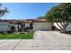 Charming single-story home with a two car garage, beautiful tile roof and manicured front yard at 5055 E Paseo Way, Phoenix, AZ 85044