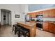 Well-equipped kitchen featuring stainless steel appliances, a center island with seating, and ample counter space at 5055 E Paseo Way, Phoenix, AZ 85044