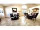 Bright, open living space featuring neutral tones, dark furniture, and tiled flooring at 5055 E Paseo Way, Phoenix, AZ 85044