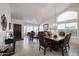 Elegant living room features a tile floor, dining table, and large window providing natural light at 5055 E Paseo Way, Phoenix, AZ 85044
