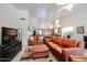 Bright and airy living room with leather sofas, open to the kitchen and dining area at 5055 E Paseo Way, Phoenix, AZ 85044