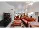 Spacious living area features comfortable seating, a media center, and an open layout to the kitchen at 5055 E Paseo Way, Phoenix, AZ 85044