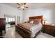 Serene main bedroom showcasing a large bed, tiled floors, and a sliding door mirrored closet at 5055 E Paseo Way, Phoenix, AZ 85044