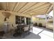 Cozy covered patio featuring a dining table and ample seating for outdoor enjoyment at 5055 E Paseo Way, Phoenix, AZ 85044