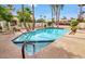 Refreshing community pool surrounded by lush landscaping and lounge chairs for relaxation at 5055 E Paseo Way, Phoenix, AZ 85044