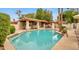 Inviting community pool with lounge area and desert landscaping offers a resort-style experience at 5055 E Paseo Way, Phoenix, AZ 85044