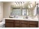 Well-lit bathroom with large vanity, large mirror, and shower/tub combo at 5518 E Lindstrom Ln # 2011, Mesa, AZ 85215