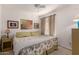 Inviting bedroom with a patterned quilt, a ceiling fan, and natural lighting at 5518 E Lindstrom Ln # 2011, Mesa, AZ 85215