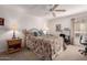 Cozy bedroom features a ceiling fan, floral bedding, and a side table at 5518 E Lindstrom Ln # 2011, Mesa, AZ 85215