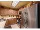 Functional kitchen area with stainless steel appliances, light wood cabinets, and ample counter space at 5518 E Lindstrom Ln # 2011, Mesa, AZ 85215