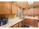 Corner kitchen features stainless steel appliances, plenty of cabinets, and natural lighting at 5518 E Lindstrom Ln # 2011, Mesa, AZ 85215