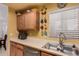 Bright kitchen with stainless steel sink, neutral countertops, and ample cabinet space at 5518 E Lindstrom Ln # 2011, Mesa, AZ 85215