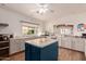 Bright kitchen with a blue island, plenty of cabinets, and a large window providing ample natural light at 5518 E Lindstrom Ln # 2011, Mesa, AZ 85215