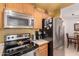 Kitchen with stainless steel appliances including a microwave, refrigerator, and range/oven at 5518 E Lindstrom Ln # 2011, Mesa, AZ 85215