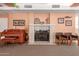 Cozy living room with a beautiful fireplace, piano, and comfortable seating at 5518 E Lindstrom Ln # 2011, Mesa, AZ 85215
