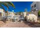 Community patio with a grill, lounge chairs, and access to a refreshing pool at 5518 E Lindstrom Ln # 2011, Mesa, AZ 85215