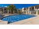 Community pool with palm trees and desert landscaping at condo complex at 5518 E Lindstrom Ln # 2011, Mesa, AZ 85215