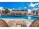 Relaxing pool area with lounge chairs, inviting blue water, and a beautiful building backdrop under a sunny sky at 5518 E Lindstrom Ln # 2011, Mesa, AZ 85215