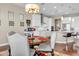 Cozy dining room with a round table, comfortable chairs, and a view into the modern kitchen at 5942 W Cactus Wren Way, Florence, AZ 85132