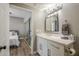 Bathroom featuring a modern vanity with great lighting, a sink, and a peek into the Primary bedroom at 7009 E Acoma Dr # 1044, Scottsdale, AZ 85254