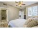 A serene bedroom featuring a bathroom, a comfortable bed, and natural light from a window at 7009 E Acoma Dr # 1044, Scottsdale, AZ 85254