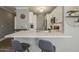 Contemporary kitchen with a breakfast bar, stainless steel appliances, and stylish white cabinets for modern living at 7009 E Acoma Dr # 1044, Scottsdale, AZ 85254
