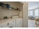 Convenient laundry room with washer and dryer, next to a dining area at 7009 E Acoma Dr # 1044, Scottsdale, AZ 85254