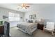 Bright bedroom with a ceiling fan, soft carpet, and a large window providing natural light at 705 W Queen Creek Rd # 2158, Chandler, AZ 85248