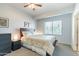 Cozy bedroom featuring a large window, ceiling fan, carpet flooring, and neutral walls at 705 W Queen Creek Rd # 2158, Chandler, AZ 85248