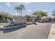 Welcoming entrance to the community featuring lush landscaping and mature palm trees at 705 W Queen Creek Rd # 2158, Chandler, AZ 85248