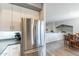 Bright kitchen featuring stainless steel fridge, white cabinets, and a view to the dining area at 705 W Queen Creek Rd # 2158, Chandler, AZ 85248