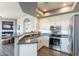 Bright kitchen with white cabinets, stainless steel appliances, and a gray countertop peninsula at 705 W Queen Creek Rd # 2158, Chandler, AZ 85248