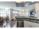 Kitchen with modern appliances, stone counter, and open plan to the living and dining areas at 705 W Queen Creek Rd # 2158, Chandler, AZ 85248