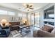 A beautifully staged living room with neutral colors and access to an outdoor patio at 705 W Queen Creek Rd # 2158, Chandler, AZ 85248