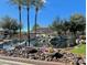 Beautiful water feature in community featuring lush landscaping and mature palm trees at 705 W Queen Creek Rd # 2158, Chandler, AZ 85248