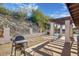Backyard featuring a built-in grill, pergola, and fenced pool area overlooking a natural desert hillside at 7607 N 22Nd Pl, Phoenix, AZ 85020