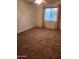 Neutral carpeted bedroom featuring bright window and ceiling fan at 7607 N 22Nd Pl, Phoenix, AZ 85020