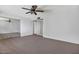 Open bedroom with neutral carpet, ceiling fan, and mirrored closet doors at 7607 N 22Nd Pl, Phoenix, AZ 85020