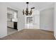 Open dining area featuring a unique chandelier and seamless transition to the kitchen at 7607 N 22Nd Pl, Phoenix, AZ 85020
