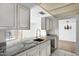 Bright kitchen with granite countertops, white cabinetry, and tile flooring at 7607 N 22Nd Pl, Phoenix, AZ 85020
