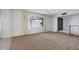 Cozy carpeted room with a large window providing ample natural light and stylish front door at 7607 N 22Nd Pl, Phoenix, AZ 85020