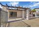 The backyard patio features a pergola, a sliding door and a small table with a grill nearby at 7607 N 22Nd Pl, Phoenix, AZ 85020