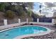Private backyard pool with stone landscaping, a fence, and lush desert foliage at 7607 N 22Nd Pl, Phoenix, AZ 85020