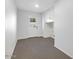 Small room with carpet, white walls, cabinets, and outside access at 7607 N 22Nd Pl, Phoenix, AZ 85020