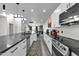 Modern kitchen with white cabinetry, dark countertops, and state-of-the-art stainless steel appliances at 7663 E Pleasant Run, Scottsdale, AZ 85258