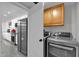 The laundry room has front loading washer and dryer with folding space at 7663 E Pleasant Run, Scottsdale, AZ 85258