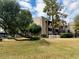 Condominium building exterior features mature trees and well-maintained landscaping in a grassy courtyard at 7777 E Main St # 163, Scottsdale, AZ 85251