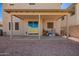 Covered back patio and low maintenance backyard with gravel ground cover at 8430 W Atlantis Way, Tolleson, AZ 85353