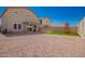 Spacious backyard with rock cover, grass play area, patio, and privacy walls offering great outdoor living at 8430 W Atlantis Way, Tolleson, AZ 85353