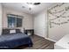 Inviting bedroom features a queen bed, ceiling fan, sliding closet door and ivy decorations at 8430 W Atlantis Way, Tolleson, AZ 85353